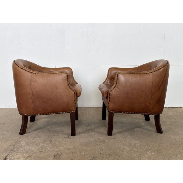 This pair of Danish club chairs was produced by Wiels Møbler in Haarby, Denmark, with the original manufacturer's label...