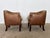 This pair of Danish club chairs was produced by Wiels Møbler in Haarby, Denmark, with the original manufacturer's label...