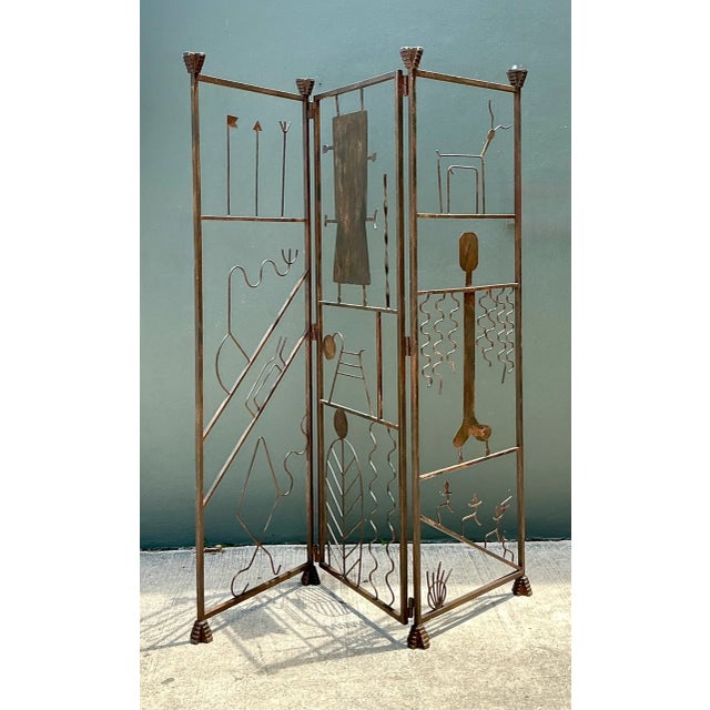 This vintage iron folding screen brings sculptural, mid-century modern character to any room with its abstract figurative...