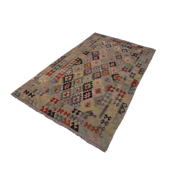 Add a touch of elegance to your home with this casual chic hand woven Tribal Kilim wool rug. Constructed on a loom by...