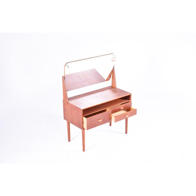 This Danish teak dresser has three drawers.