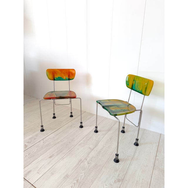 Pair of Broadway chairs, model 543. Chromed steel frame with epoxy resin seat and backrest. Spring-loaded feet with rubber...