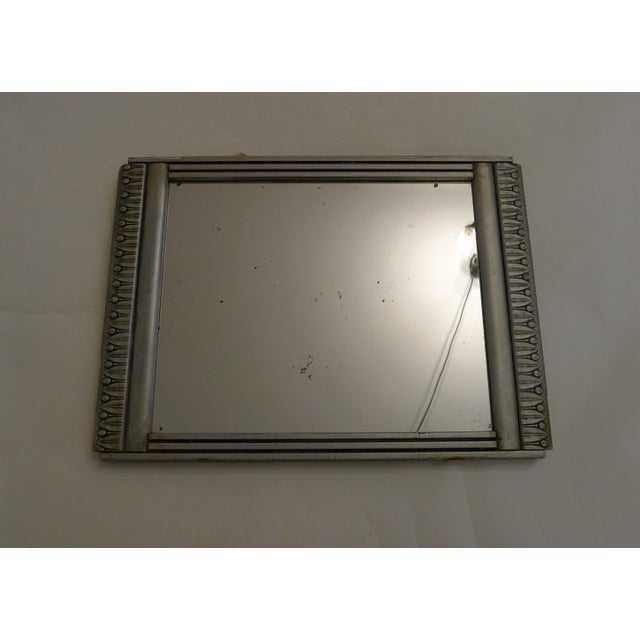 Small Art Deco wall mirror, rectangular shape, carved silvered wood frame with stylized foliage frieze and grooves; double...