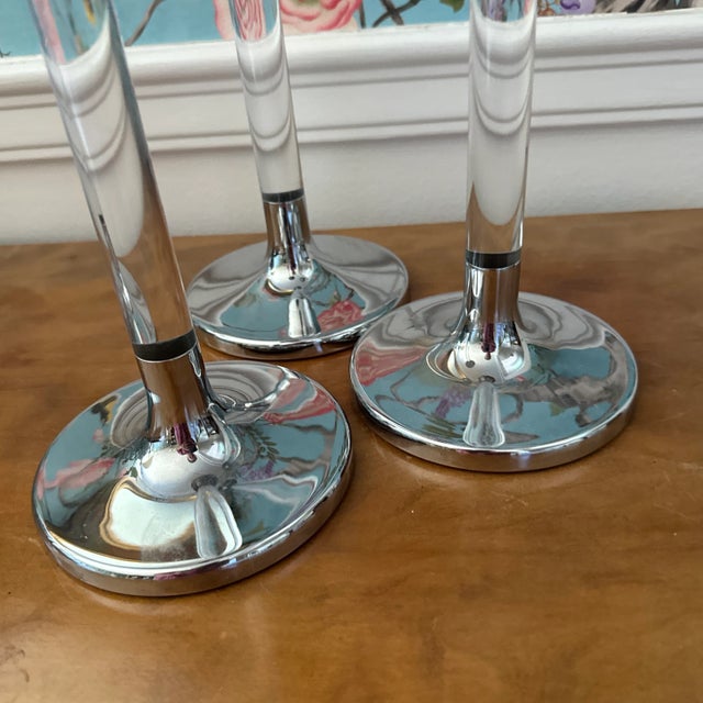 Listing is for a graduated set of 3 acrylic or lucite silver metal candlestick holders. The tallest is 20”, medium is 16”,...