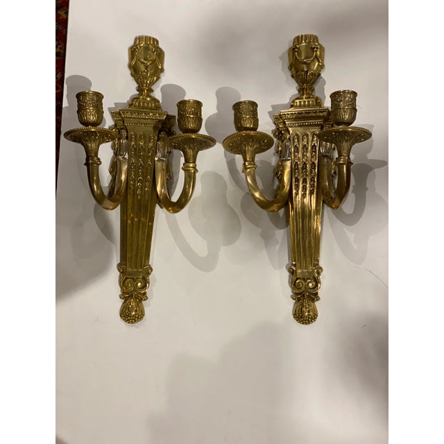 A pair of circa 1920’s gilt bronze neoclassic style sconces