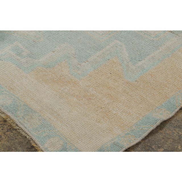 Hand-knotted in wool, this vintage 3x10 Turkish runner, circa 1950–1959, features oversized geometric medallions rendered...