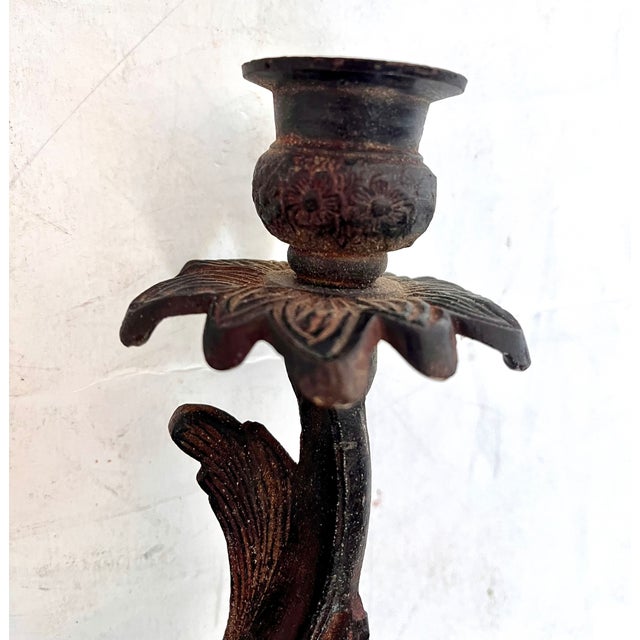 Pair of iron vine and leaf design candle holder wall sconces. Two blossom design candle holders per sconce. The sconces...