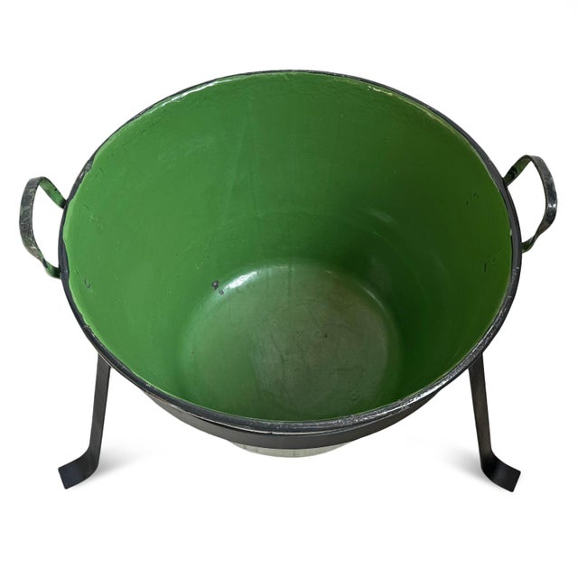 Charming vintage Hungarian enamel bucket with a rich glossy green finish paired with a black iron stand, blending European...