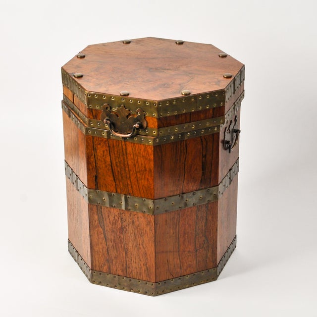 A unique and fine piece of antique furniture, this rare mahogany chest features brass reinforcements, two handles for...