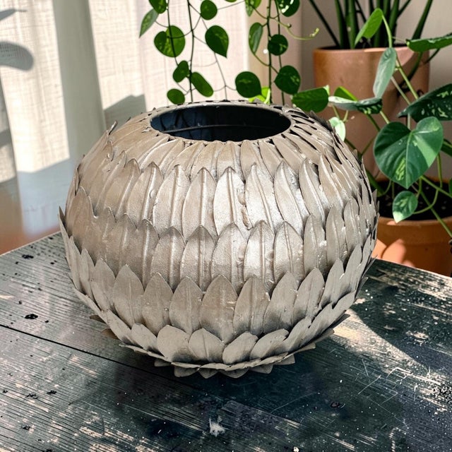 Elevate your home decor with this Decorative Silver Metal Artichoke Leaf Vase, a stunning centerpiece that combines...