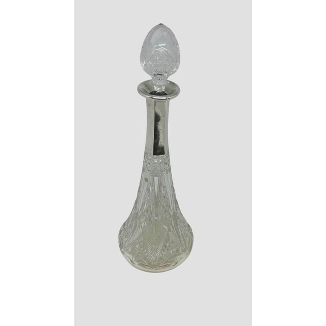 This object is a vintage cut crystal wine or liquor decanter, featuring a detailed diamond and fan cut pattern on its...