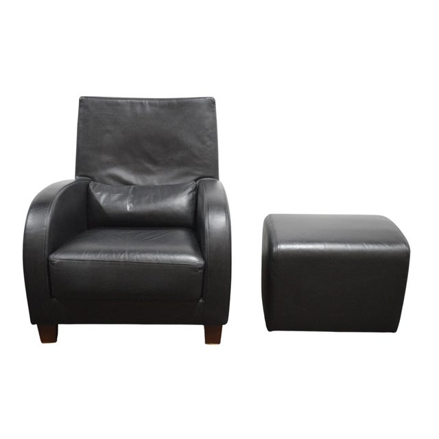 A fine modern black leather lounge chair with accompanying ottoman from Ligne Roset. Tight clean lines and high-end black...