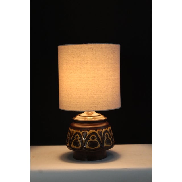Roberto Rigon style lamp. Embossed ceramic glazed in coco brown and mustard yellow finish. Highlighting the abstract...