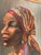 Beautiful Woman with colorful head wrap and jewelry very popular style in the mid 20th century. Strong features and...