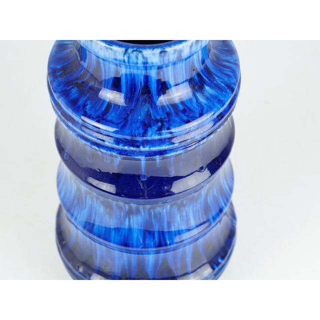 This vase from the German ceramics manufacturer Scheurich is particularly captivating due to its intense colors. The...