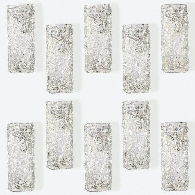Rectangle wall sconce with textured clear glass. They are fabricated with a silver colored back plate, high-end pieces....