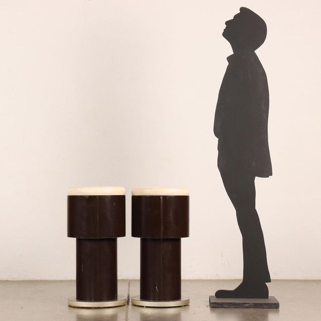 Pair of stools in lacquered wood with foam padding and imitation leather covering. This piece is attributed to the...