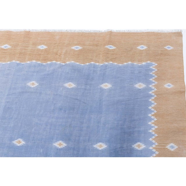 This elegant 1955 Indian Dhurrie rug showcases the refined simplicity and enduring craftsmanship characteristic of...