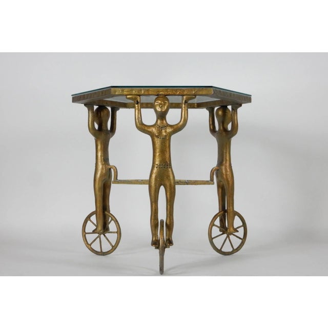 Incredible mid 20th century Gueridon table cast in iron with gold enamel finish. Legs are androgynous figures standing on...