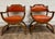 This is a gorgeous and rare pair of vintage Victorian style carved walnut Savonarola parlor arm chairs with orange or...