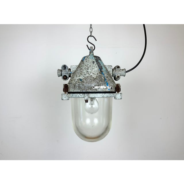 Grey industrial explosion proof light with massive protective glass bulb. Made in former Czechoslovakia by Elektrosvit...