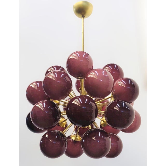 Italian sputnik chandelier with 24 frosted amethyst Murano glass globes mounted on brass frame in unlacquered natural...