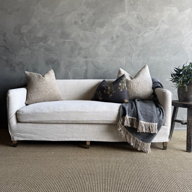 Clayton Slip Covered Sofa Shown: Slip covered in a heavy stone washed Belgian linen in Semi-Bleached neutral Greige Legs:...