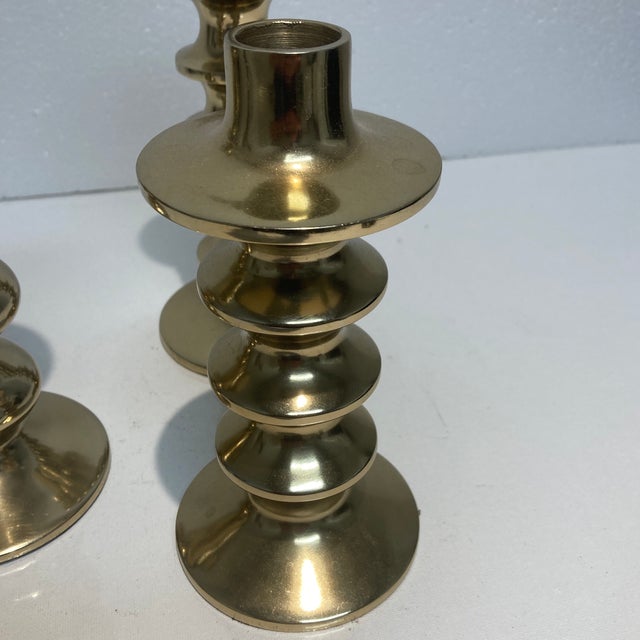 Candleholders with a gold finish with a spindle-shaped. Can hold taper candles. The largest size 10 1/2 inches high...