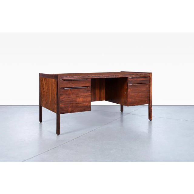 Fabulous Danish modern executive rosewood desk, designed in Denmark, circa 1960s. The Brazilian rosewood desk has been...