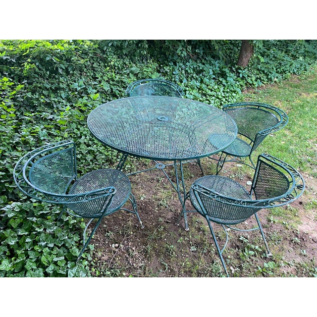 Elegant vintage patio set inspired by the timeless Woodard Briarwood style. This wrought iron mesh dining set includes one...