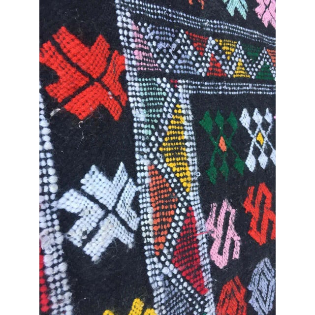 Moroccan vintage black tribal kilim rug, handwoven by Berber women in Morocco. Great mix of organic wool and cotton in...
