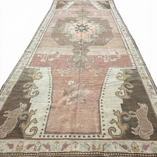 This distinctive vintage runner from Kars, Turkey, showcases the playful and symbolic elements often found in Anatolian...