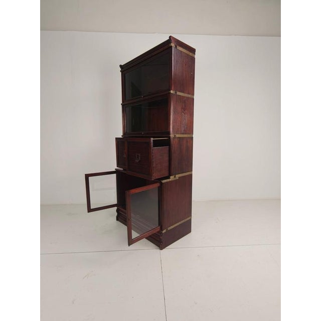 Elegant English-style bookcase in Globe-Wernicke style , made of mahogany with brass fittings and modular construction....
