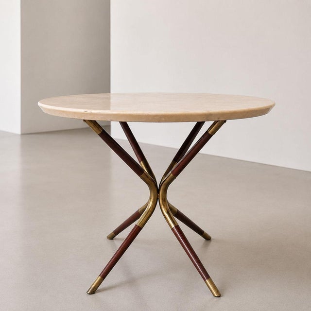 Elegant Italian coffee table attributed to Cesare Lacca, dated 1958, featuring a brass frame, wooden elements, and a...
