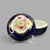 It is hand painted with a nice floral arrangement on white ground on the top of the lid with a fancy gold trim around the...
