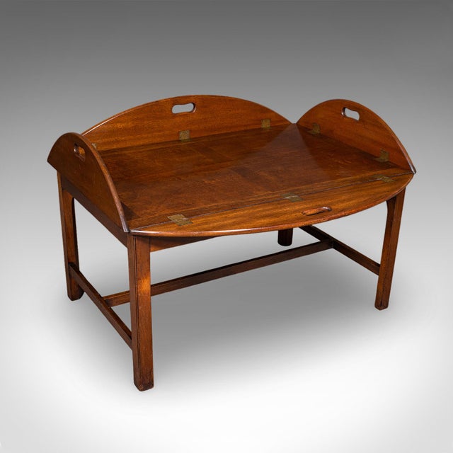 This is a large vintage butler's tray table. An English, mahogany and brass drop-flap serving stand, dating to the Art...