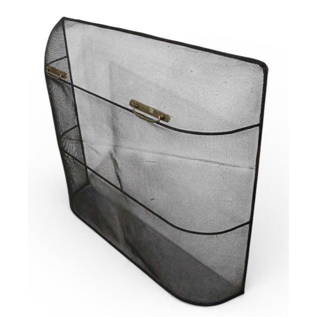 Classic Early American style fireplace screen, spark guard having a metal mesh screen, with brass handles, mounted on a...