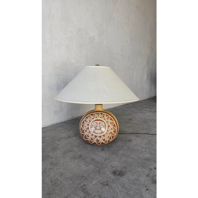 Large scale vintage ceramic lamp depicting a hand painted sun. Signed Brown. Lamp is in excellent working condition.