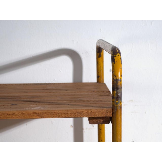 Antique industrial metal cart with three tiers and original wheels, crafted in iron and originating from Central Europe,...