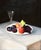 Oil painting in the Dutch style on okoume board (similar to mahogany) of a still life with an orange, a peach, three...