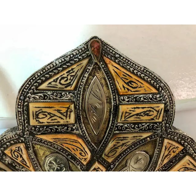 A vintage arched Moroccan vanity or wall mirror, handmade of natural bone and engraved with beautiful tribal designs. The...