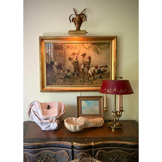 A beautifully weathered 19th-century Italian marble holy water font, hand carved in a graceful shell form and originally...