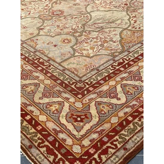 This vintage European rug with a classic Persian design features warm colorways of muted red, orange and yellow - circa...