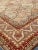 This vintage European rug with a classic Persian design features warm colorways of muted red, orange and yellow - circa...