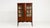 An elegant Edwardian vitrine showcasing detailed marquetry work and refined proportions. The glass panels allow for the...