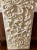 Antique wood panel with carved acanthus leaves.