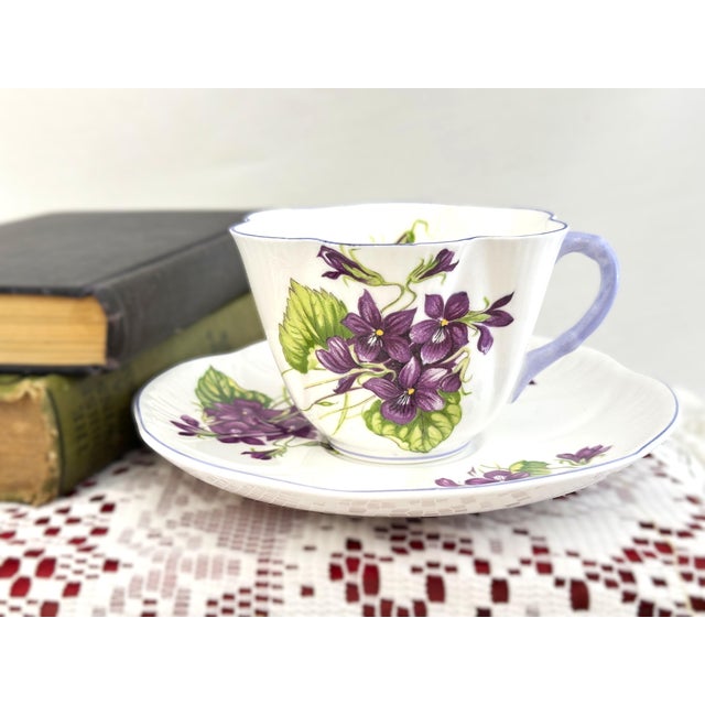 This lovely Shelley set, Violets Pattern, with purple flowers, includes a cup & saucer in Shelley’s iconic Dainty shape....