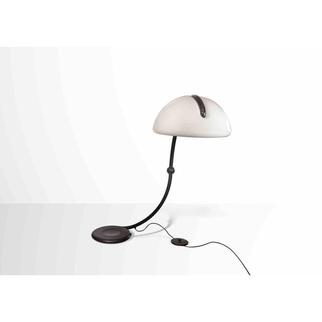 Snake Floor Lamp is a design object realized by Elio Martinelli, Italy 1960s. Diffused light, swivel arm, white opal...
