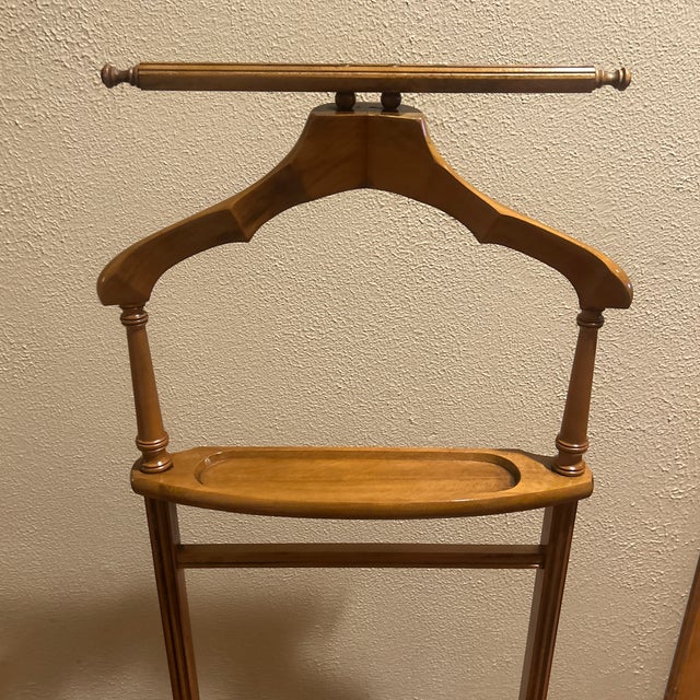 Beautiful mid-century modern wooden suit valet stand by Butler Specialty Company (Model 973). Features a contoured coat...