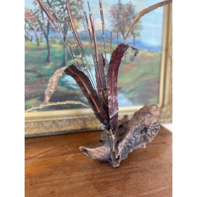 A dynamic and expressive mid-century brutalist sculpture depicting a spray of cattails and grasses, crafted from flame...